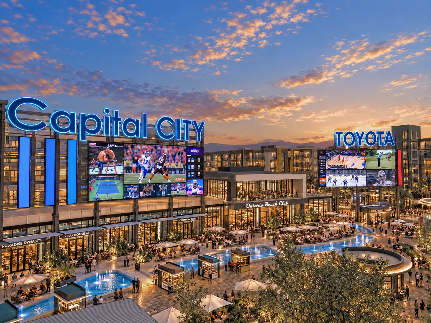 The Plaza at dusk: the Capital City sign and large screens above the patios and water